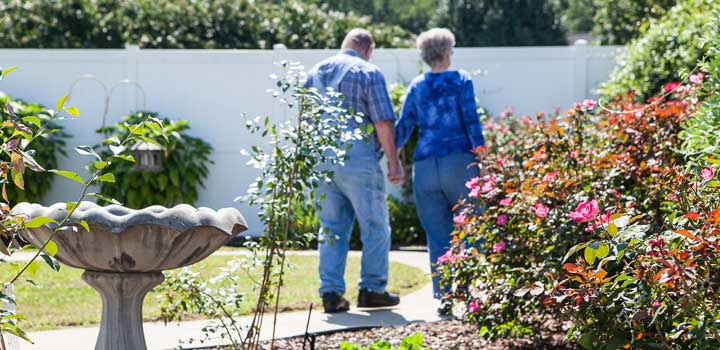 Married residents walking in garden